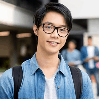 A smiling student outside on campus